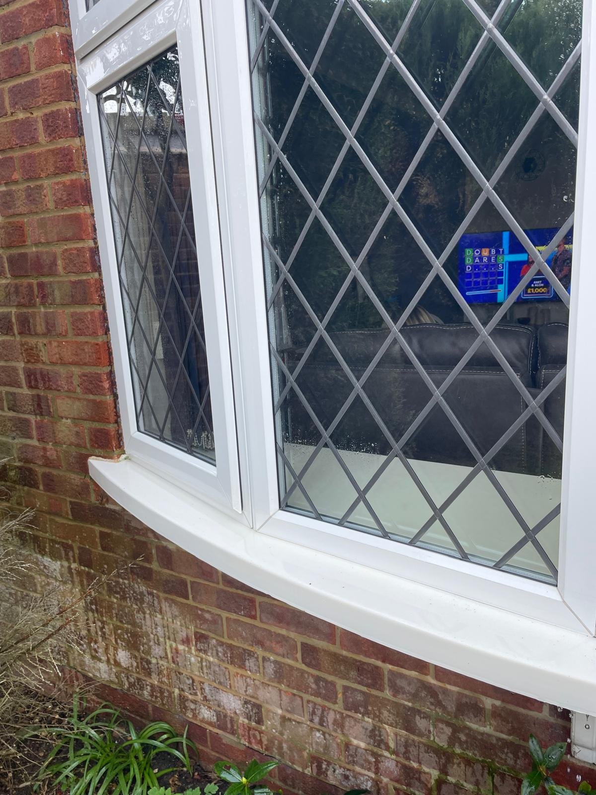 The same bay window sill spotless and bright white after cleaning